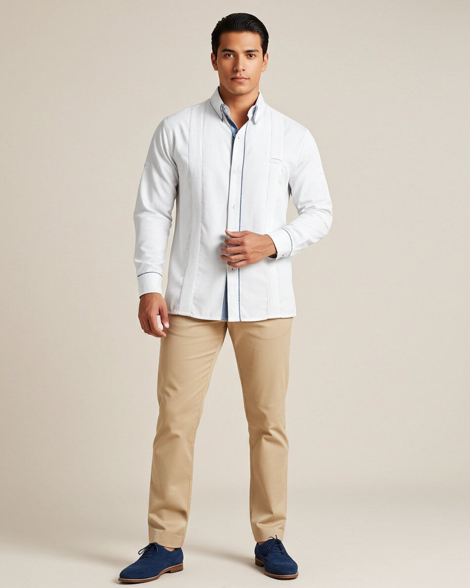 Man wearing a white shirt, beige pants, and navy shoes against a beige background