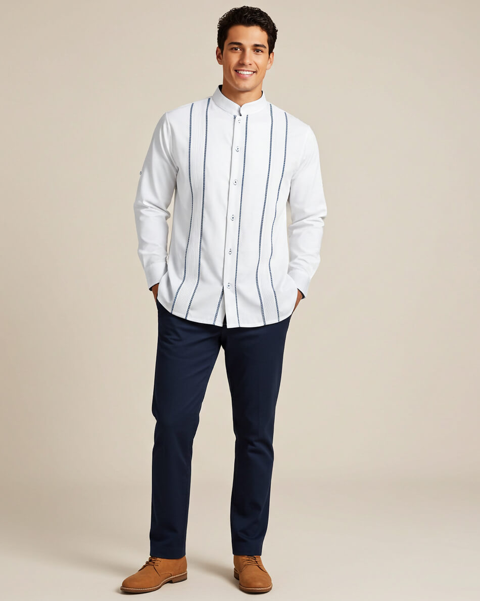 Man wearing a white shirt with navy gingham fabric accents and navy pants on a beige background