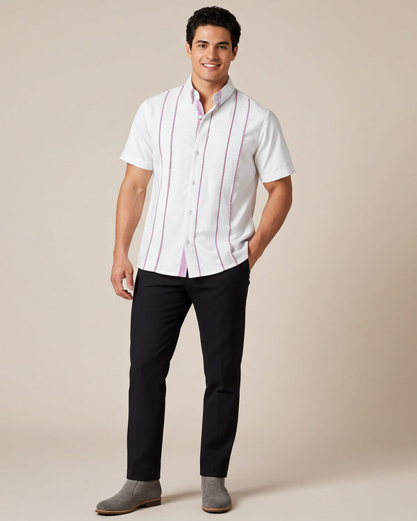 Man wearing a white shirt with purple gingham and black pants on a beige background