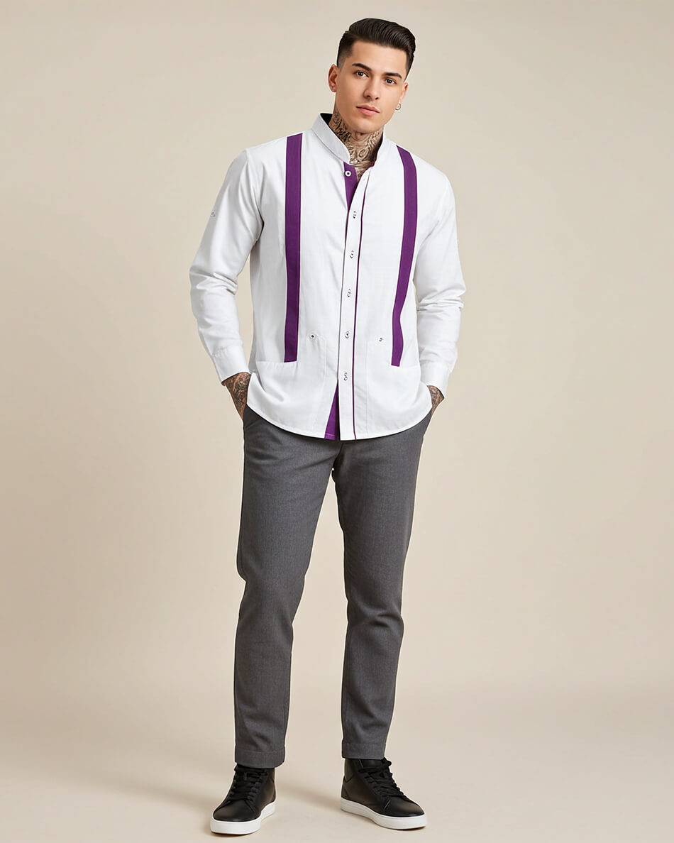 Man wearing a white long-sleeve guayabera shirt with purple accents and gray pants on a beige background