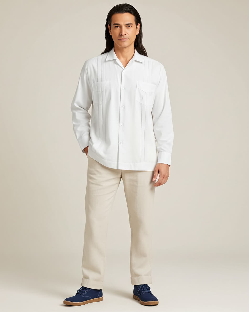 Person wearing a white guayabera shirt and beige pants against a plain background