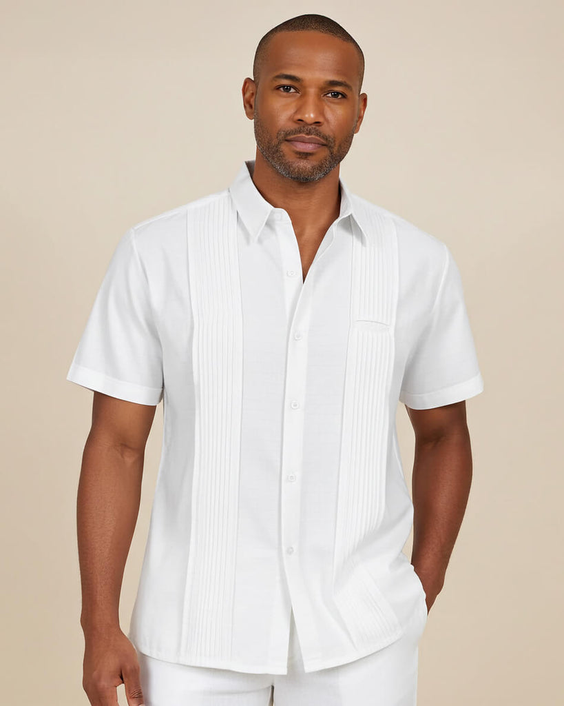 Man wearing a white guayabera short-sleeve shirt with vertical stripes against a beige background