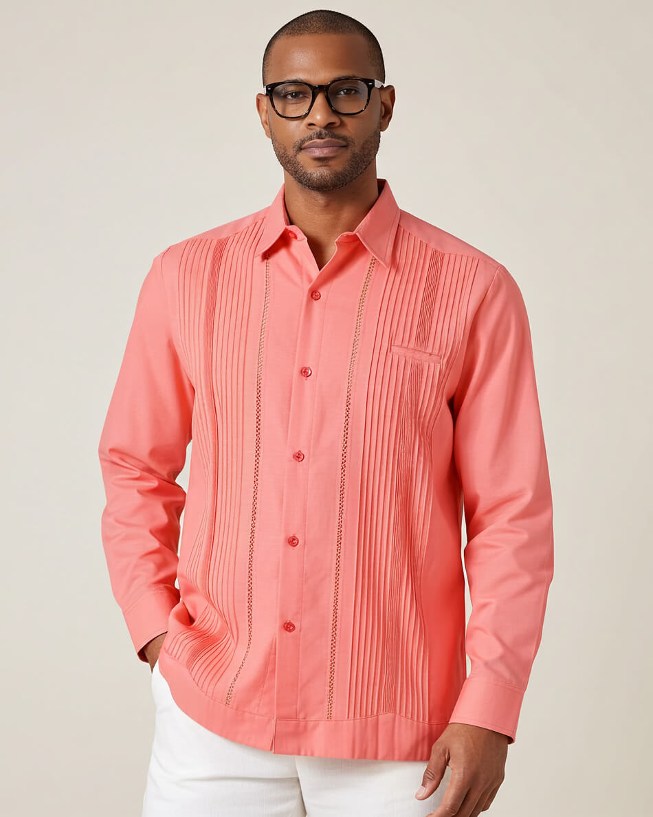 Man wearing a coral pleated guayabera shirt against a plain background