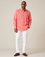 Man wearing a coral pleated guayabera shirt against a plain background