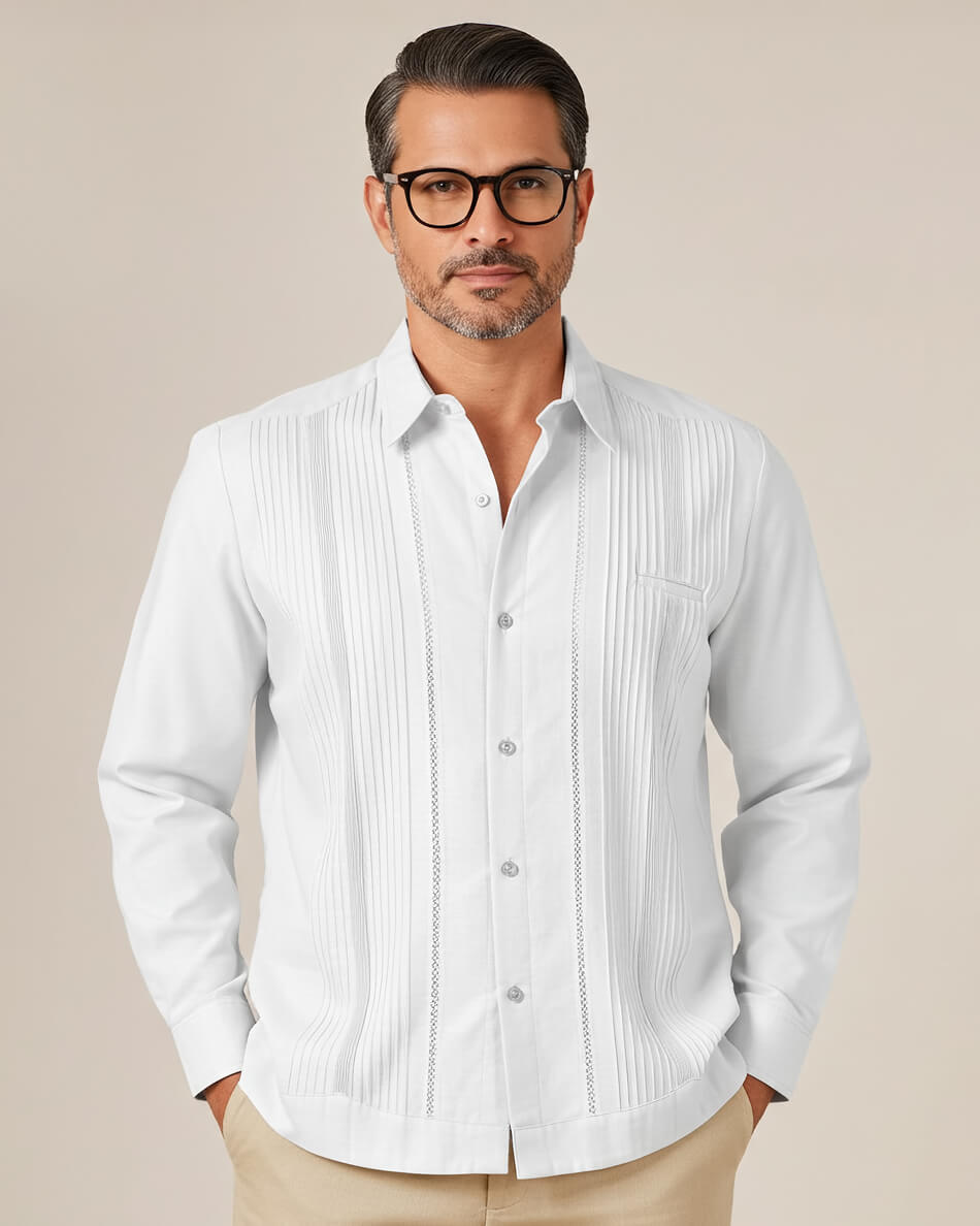 Man wearing a white button-up guayabera shirt with a subtle pattern on a beige background