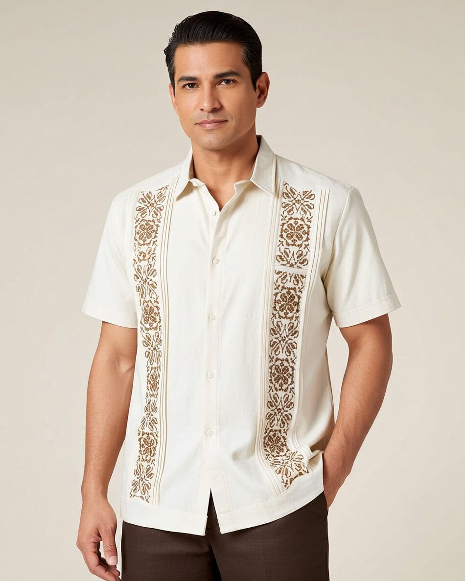 Man wearing a beige guayabera embroidered shirt against a beige background