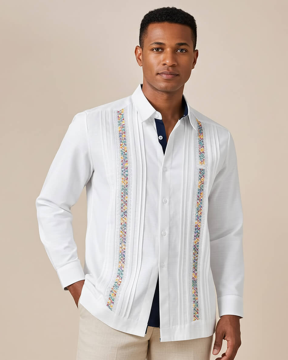 Man wearing a white guayabera embroidered shirt with a beige background